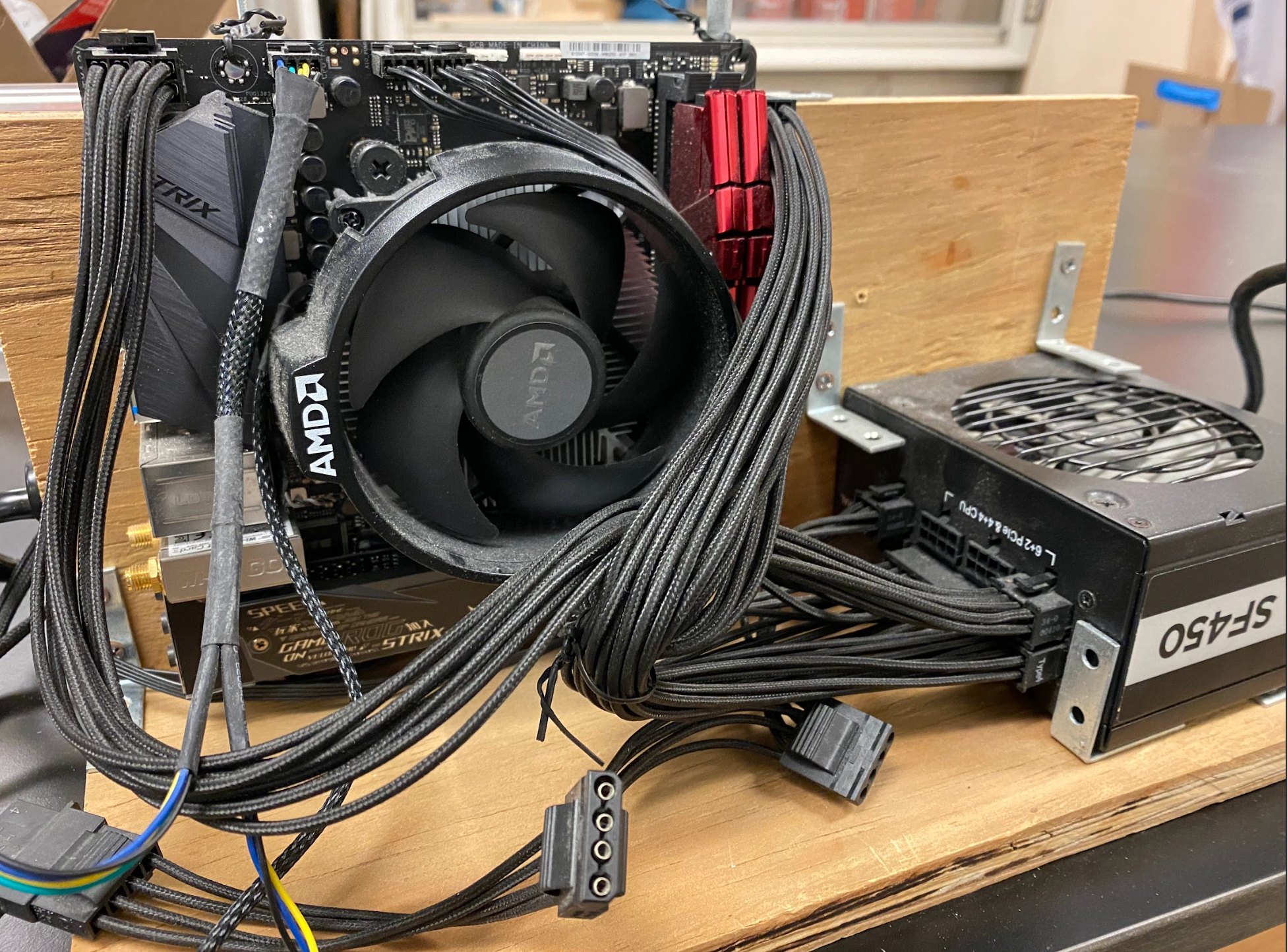 Computer hardware components and repair work showing motherboard, cooling systems, and cables