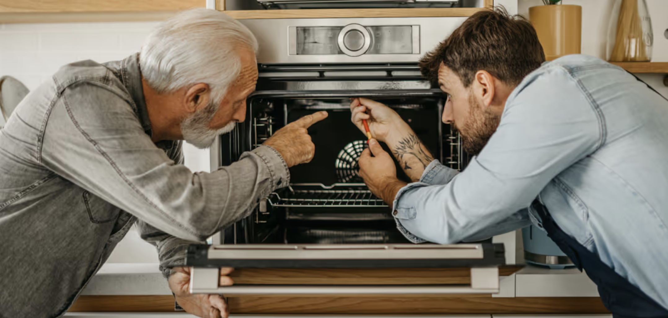 Senior man and caregiver working together on home appliance repair