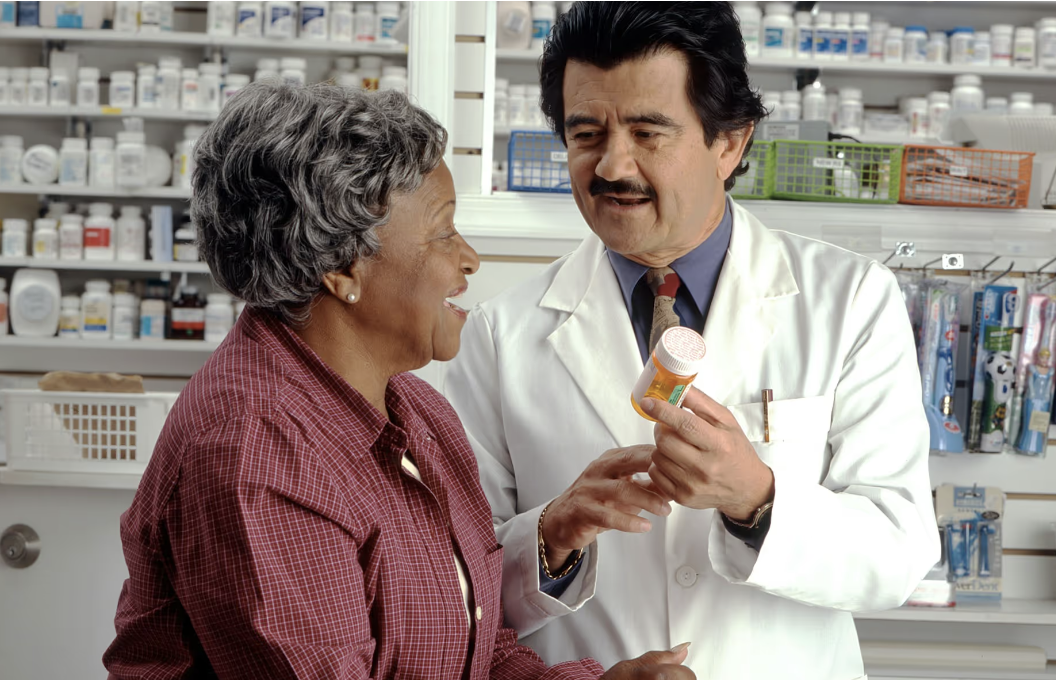 Senior woman consulting with pharmacist about prescription medication